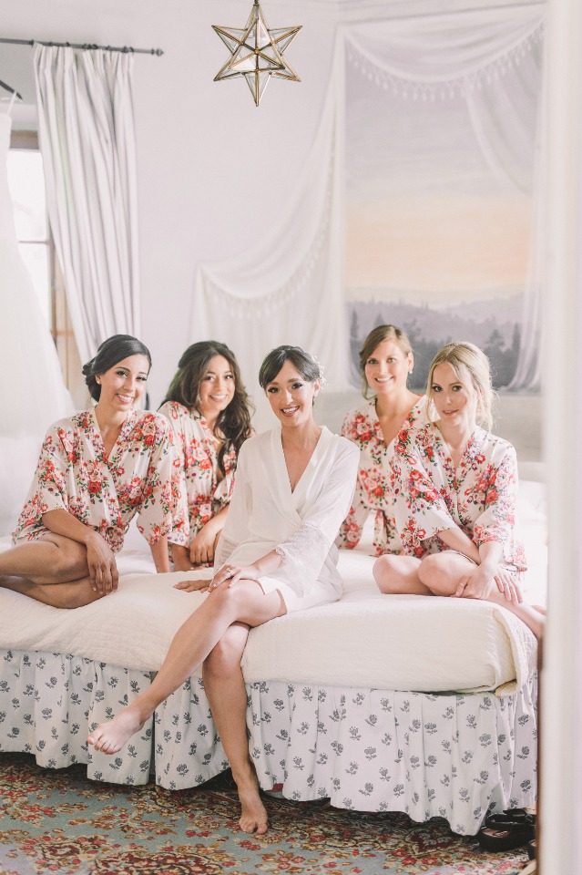 Bride and bridesmaids in floral robes on wedding day
