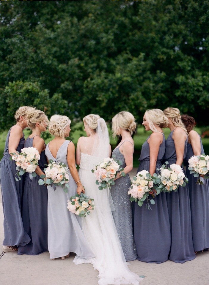 Bride with bridesmaids in grey dresses and bouquets