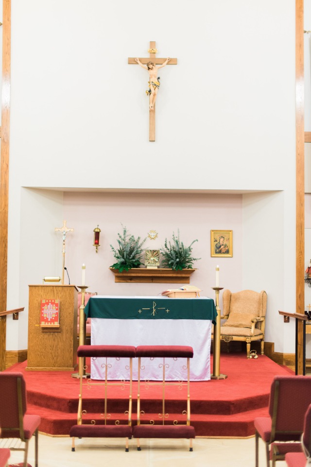Interior view of a church with a crucifix on the wall and altar