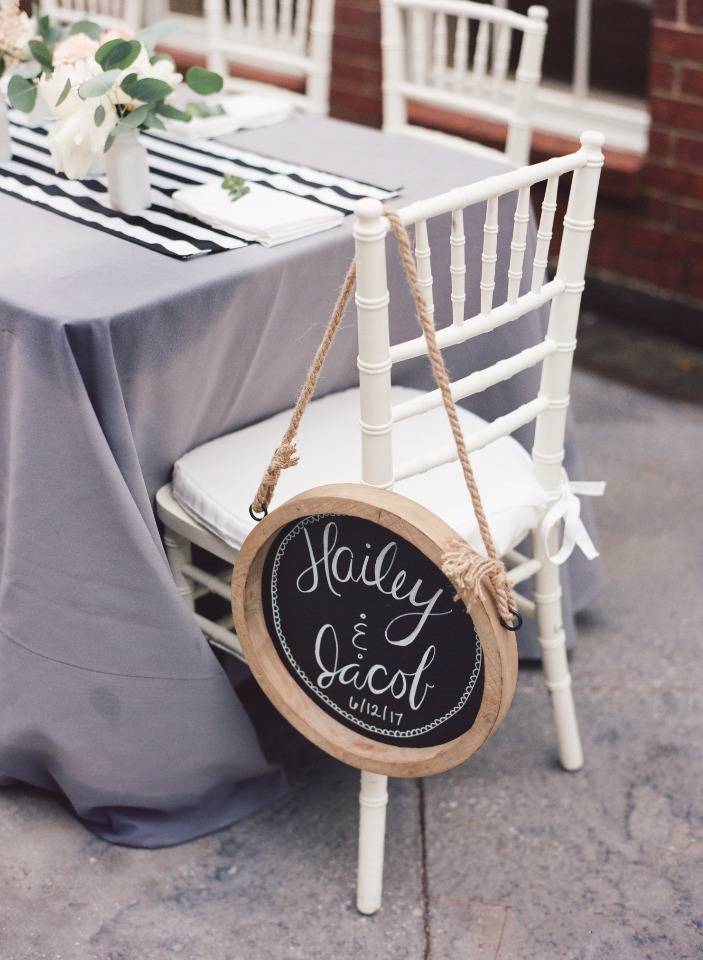 Wedding table setting with a personalized sign for the couple