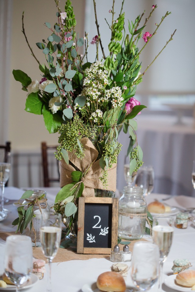 wildflower wedding reception centerpiece with chalkboard table number