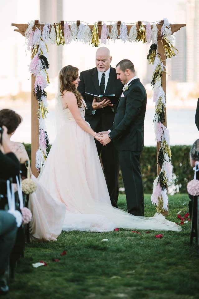 pink and gold tassel covered wedding arch