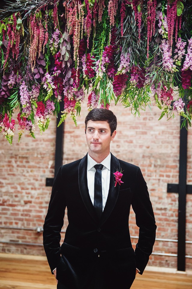 groom in classic black and white with fuchsia boutonniere