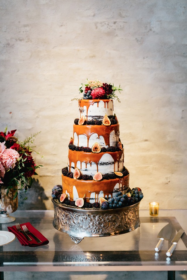 drizzle wedding cake topped with figs and flowers