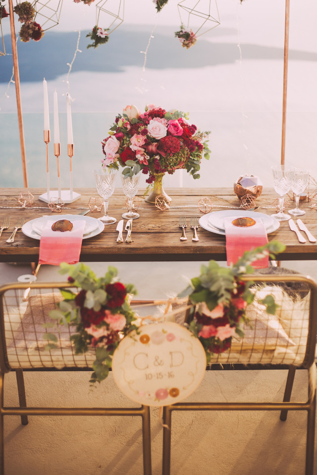 Romantic wedding table setting with flowers and water view