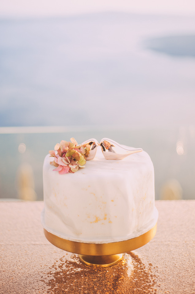 Romantic wedding cake with bird toppers and flowers