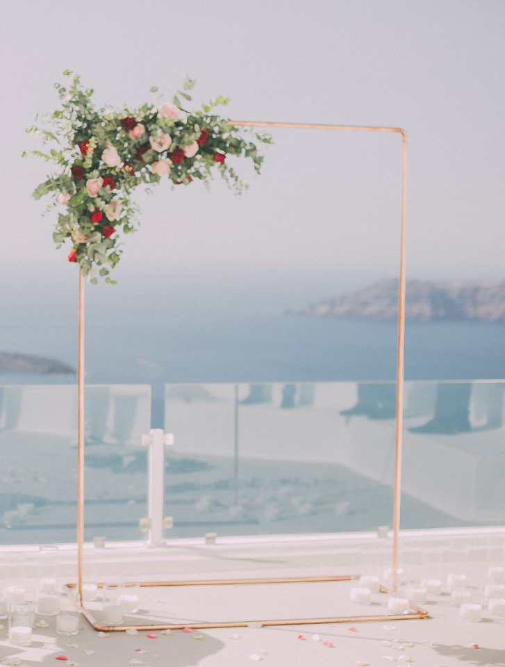 Beautiful floral arch for outdoor wedding overlooking sea