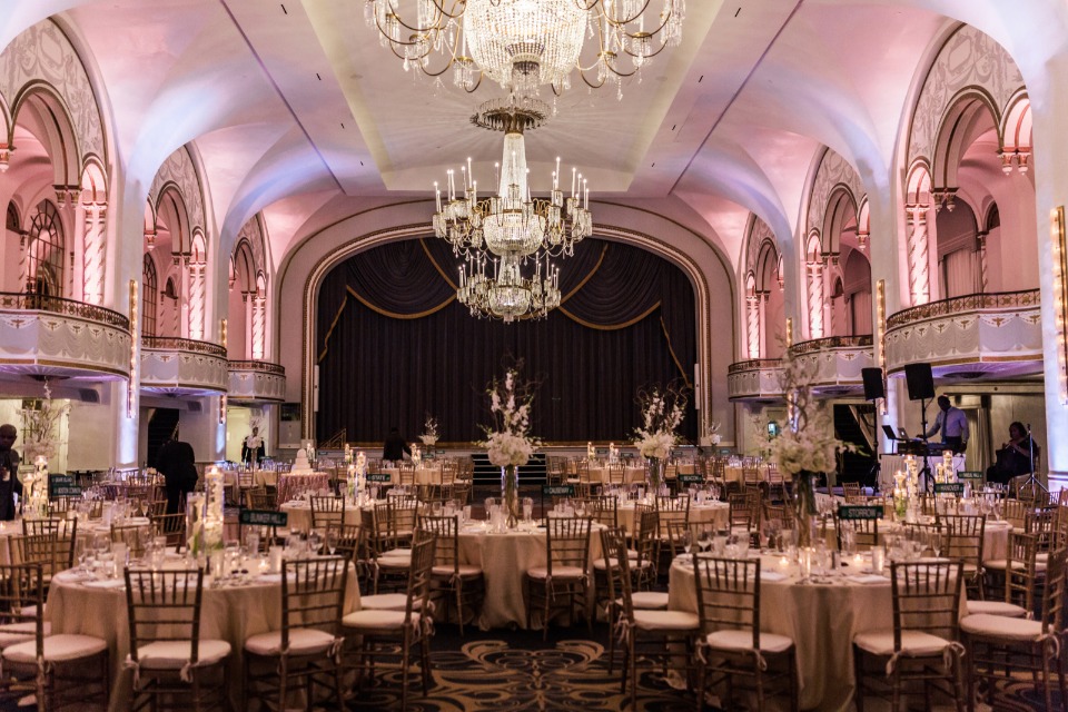 dramatic ballroom reception with pink uplighting
