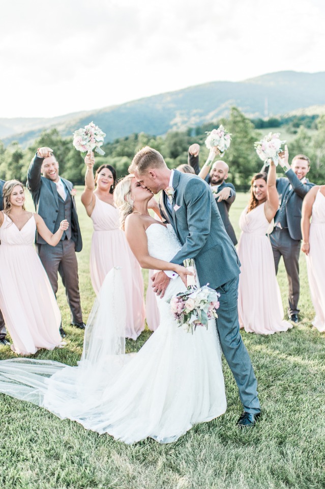 Wedding kiss with bridal party