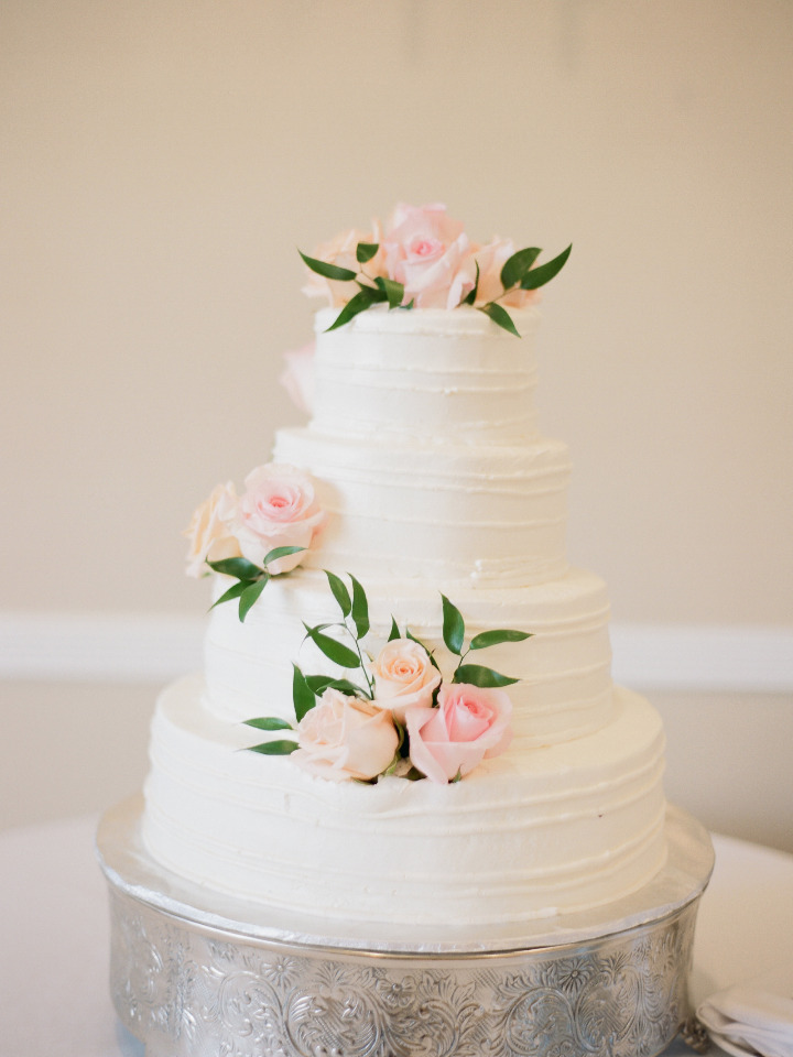 classic white wedding cake with pink roses