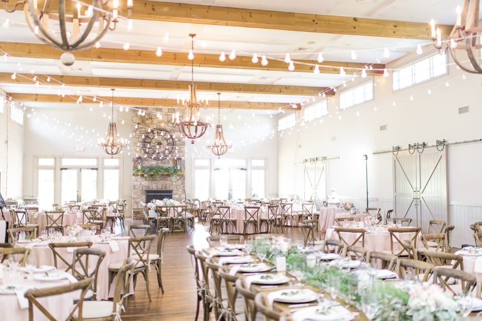 Natural white and green ceremony with bistro lights