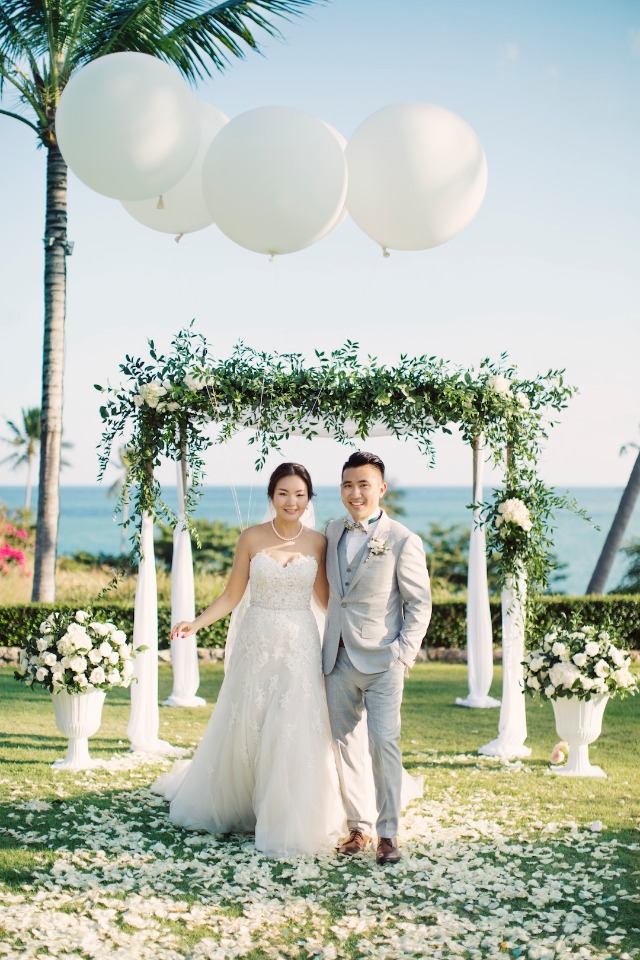 giant balloons over the floral wedding arch