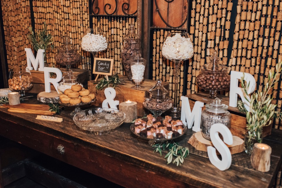 Mr and Mrs dessert table with wine cork backdrop