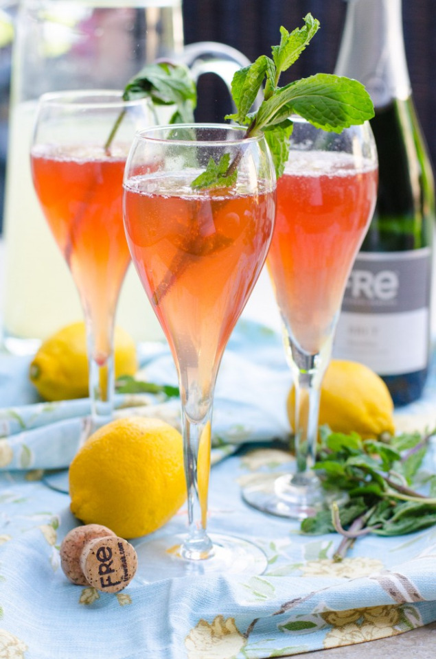 Sparkling rose cocktails with lemon and mint garnish