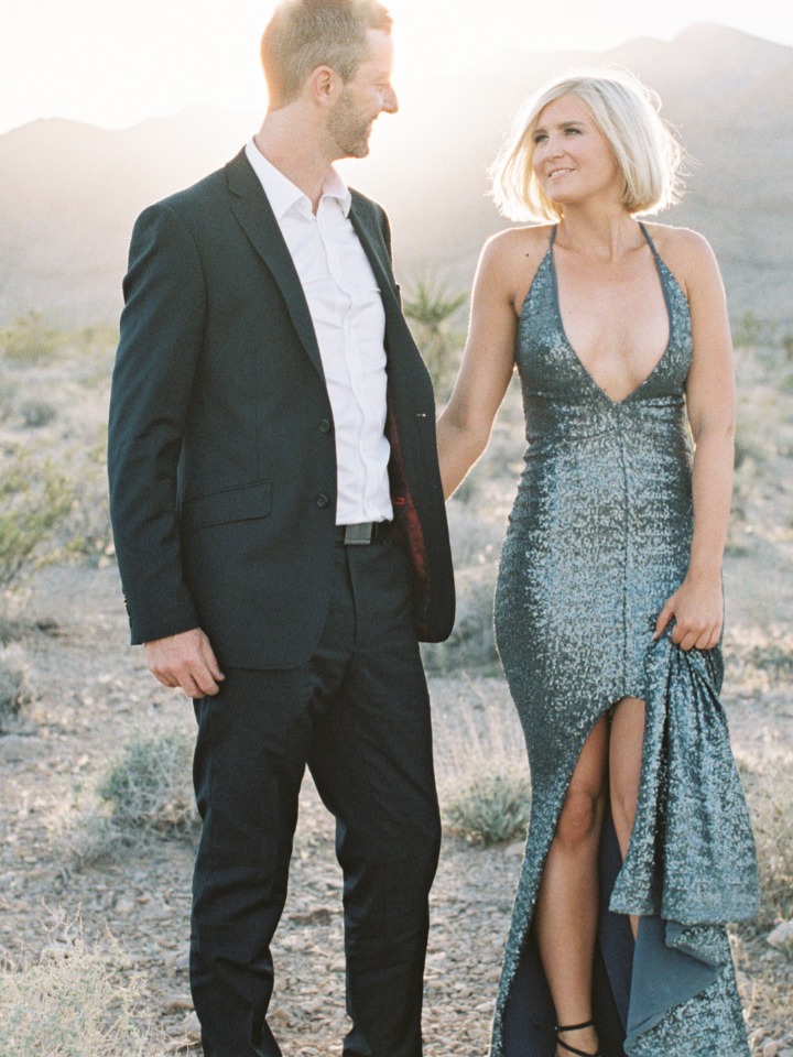 Elegant couple in formal attire in a desert setting