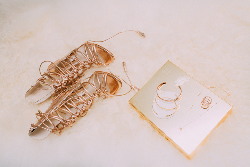 Luxurious gold strappy sandals and gold accessories