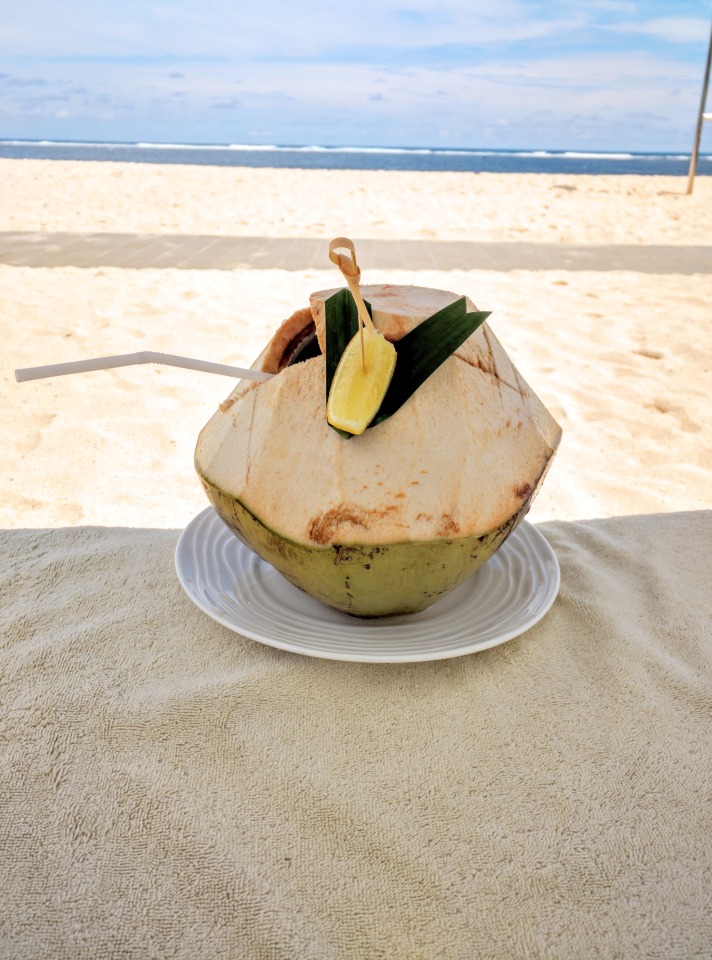 Coconut drink on the beach in Bali at The Mulia Resort