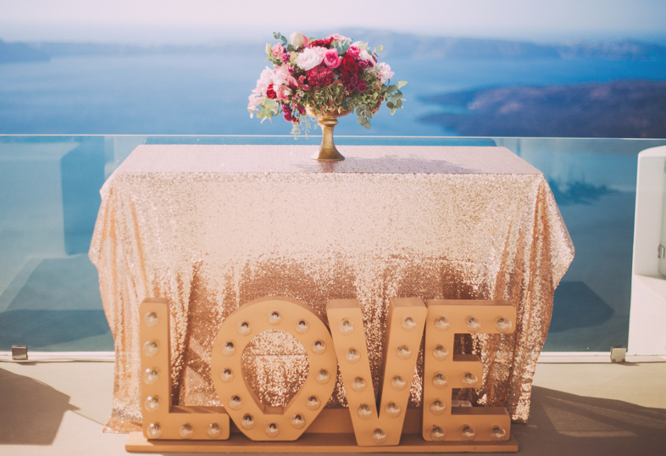 Gold sequin table with beautiful flowers and marquee LOVE sign