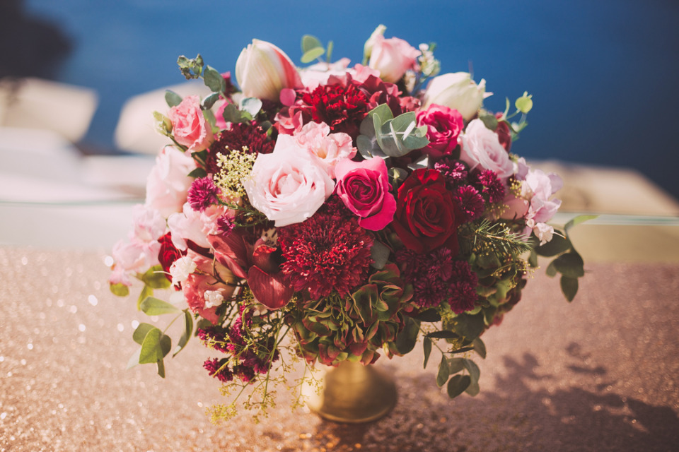 Vibrant pink and red flower bouquet on sparkly surface