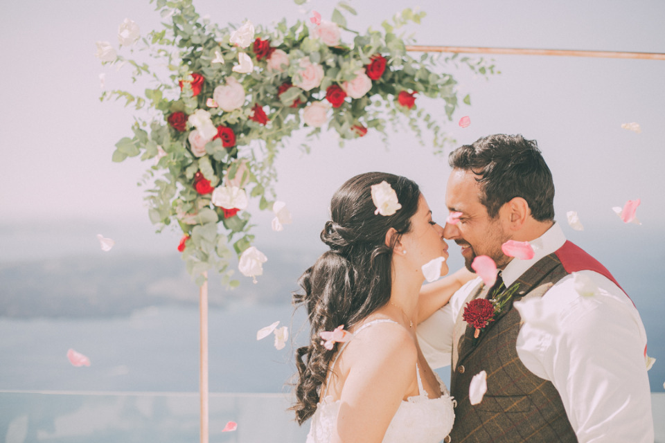 Loving couple wedding ceremony with rose petals falling