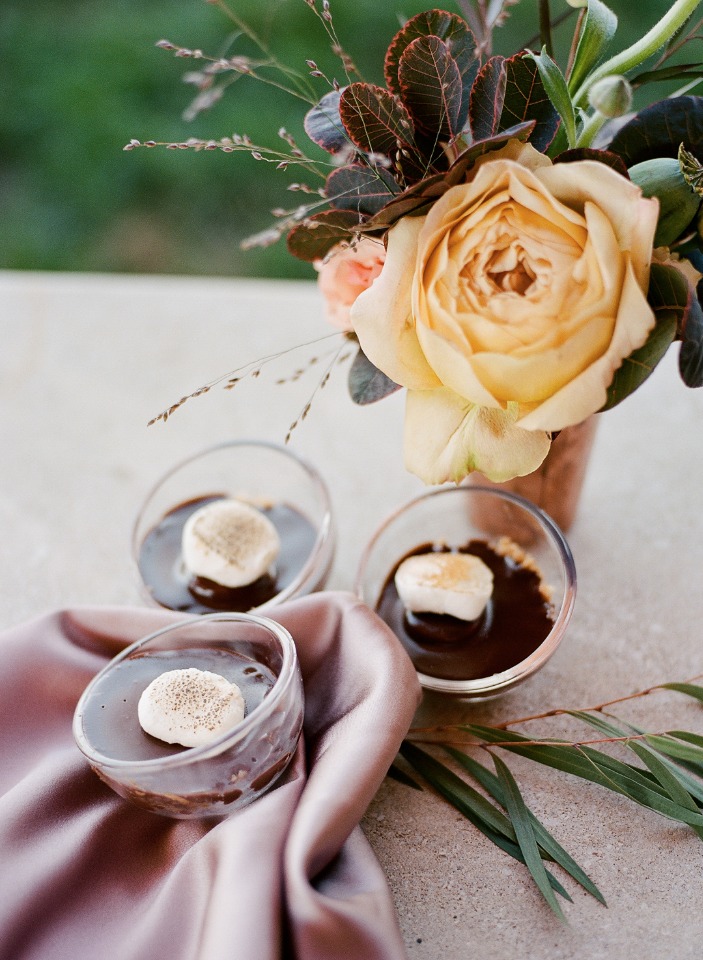 Chocolate desserts with marshmallows and floral arrangement
