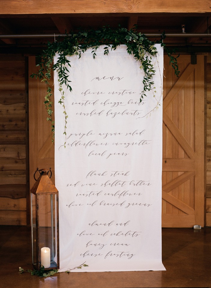 Wedding menu elegantly displayed on a fabric backdrop