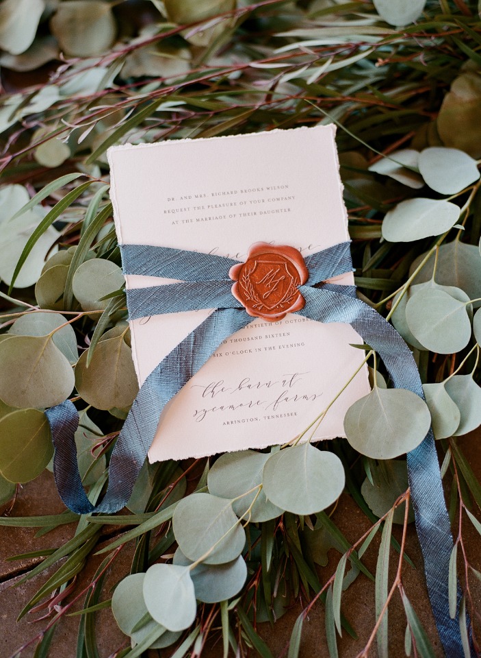 romantic wedding invite with wax seal wrapped in ribbon