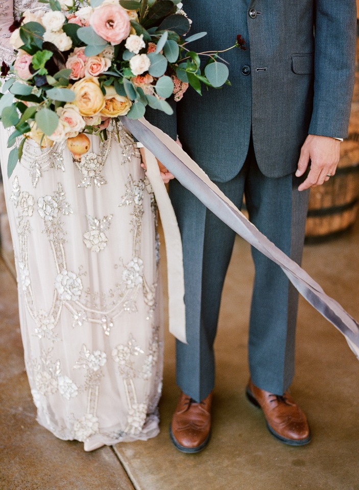 Bride and groom wedding photo with bouquet and stylish attire