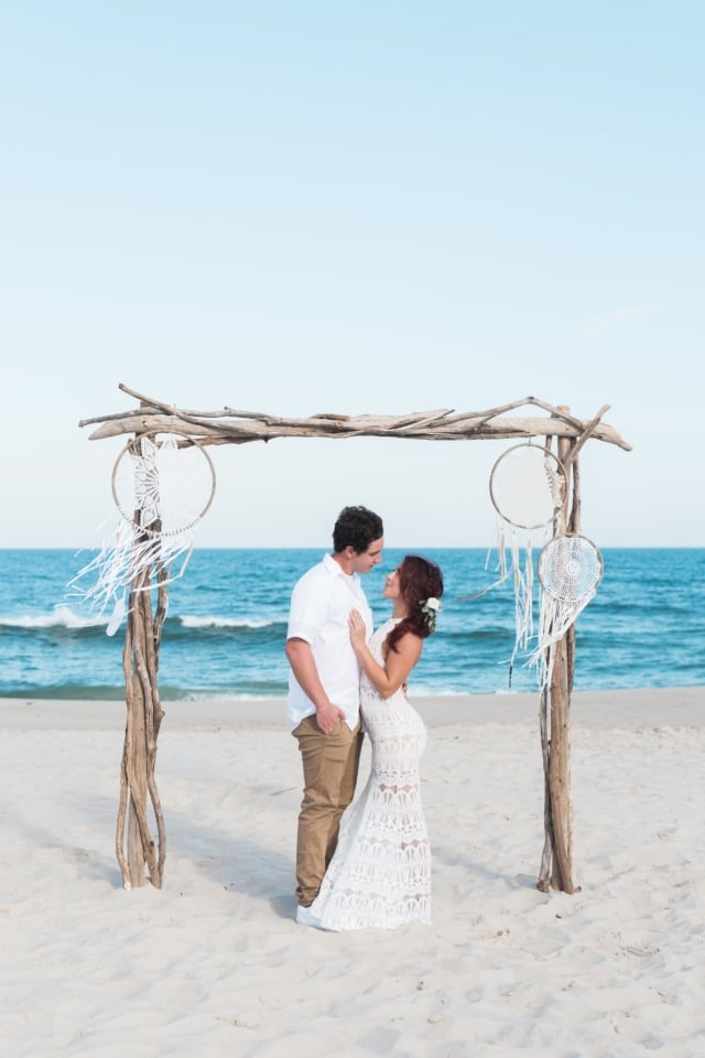 Beautiful boho beach wedding with driftwood arbor