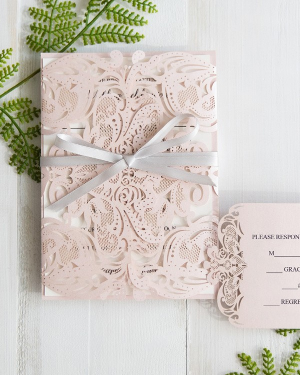 Elegant blush wedding invitation suite with laser cut design
