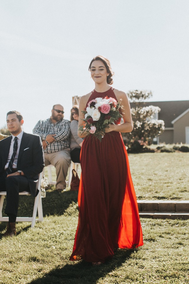 bridesmaid in red dress and white and pink bouquet