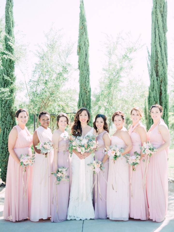 bridesmaids in long dresses of assorted pink colors