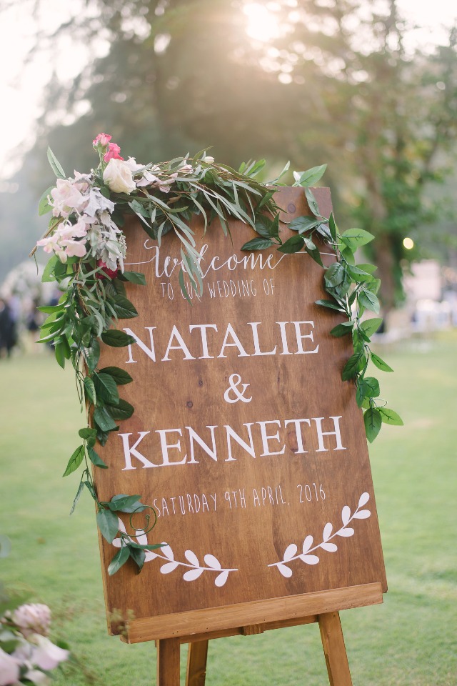 cute flower accented wedding sign