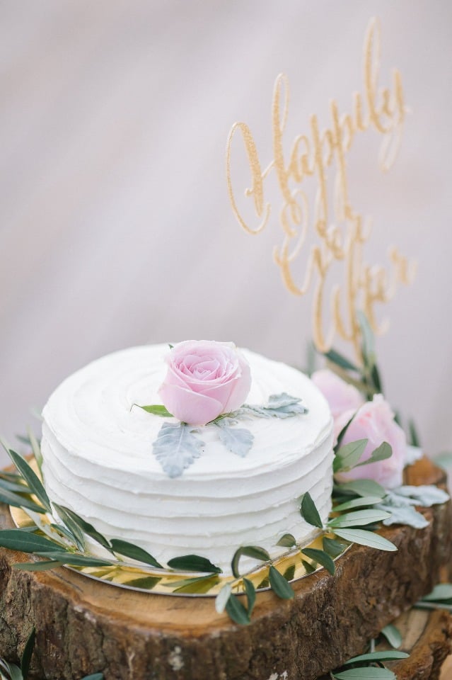 simple rose topped wedding cake