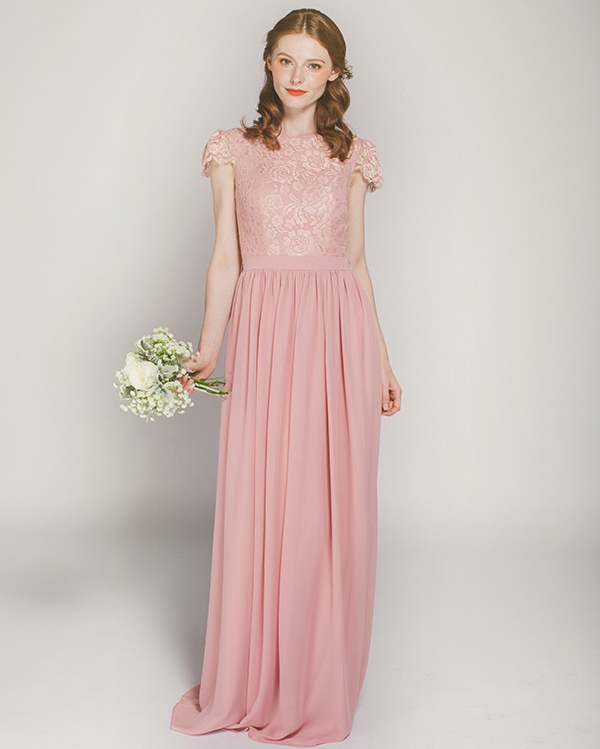 Woman in pink lace chiffon bridesmaid dress holding flowers