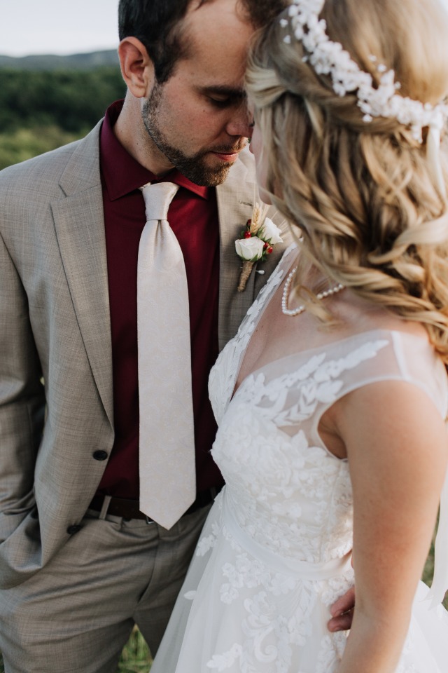 groom in grey suit and maroon shirt