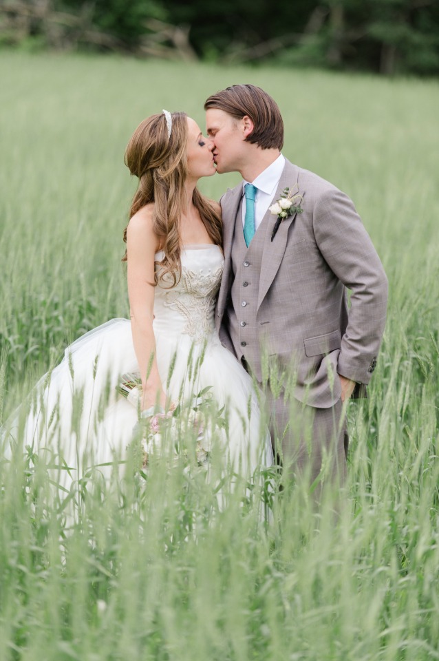 romantic wedding kiss in a field