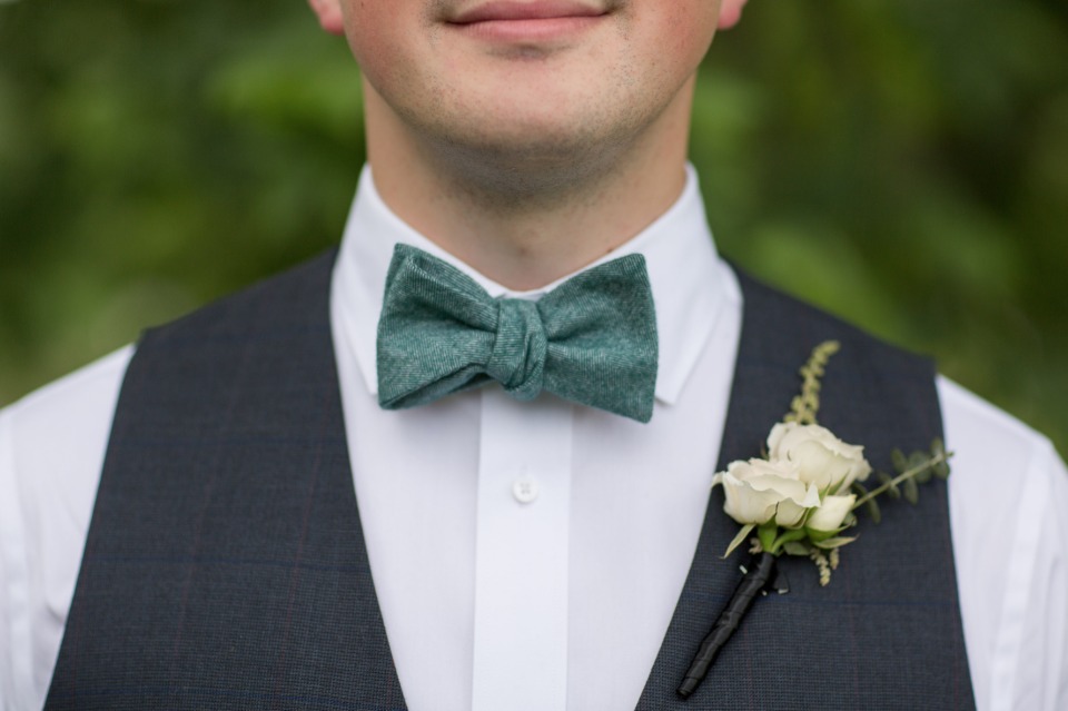groomsmen in vests and bow ties