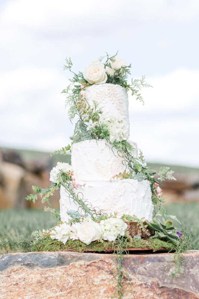 ivy climbing wedding cake topped with white roses