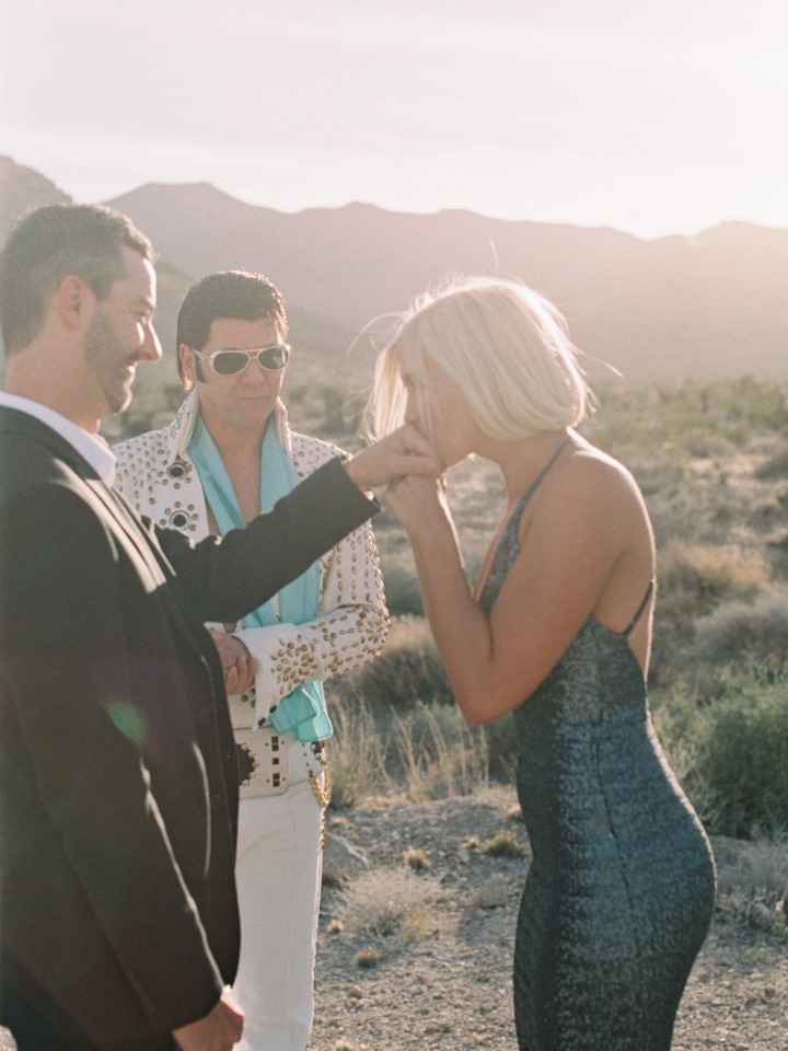 Woman kisses hand at wedding with Elvis impersonator present