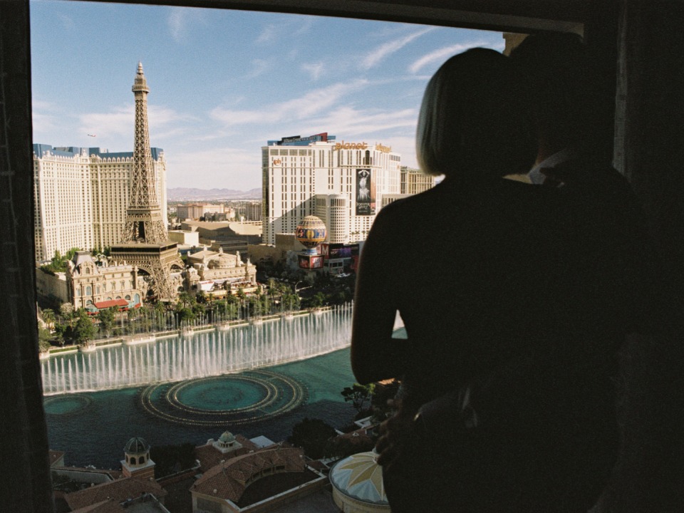 Couple admiring the Las Vegas strip view from their hotel window