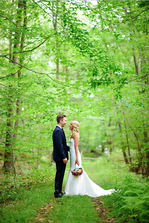 Bride and groom in a green forest wedding photo
