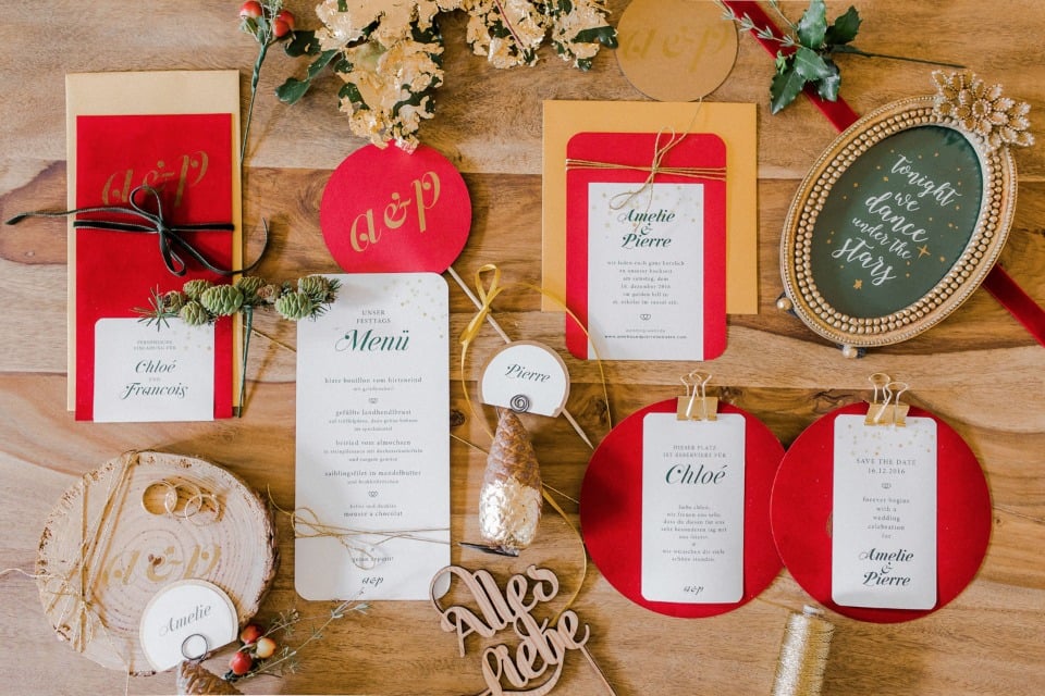 holiday themed wedding invitation suite in red and gold