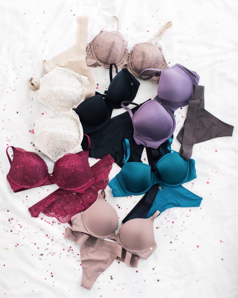 Collection of colorful bras on white fabric, lingerie options