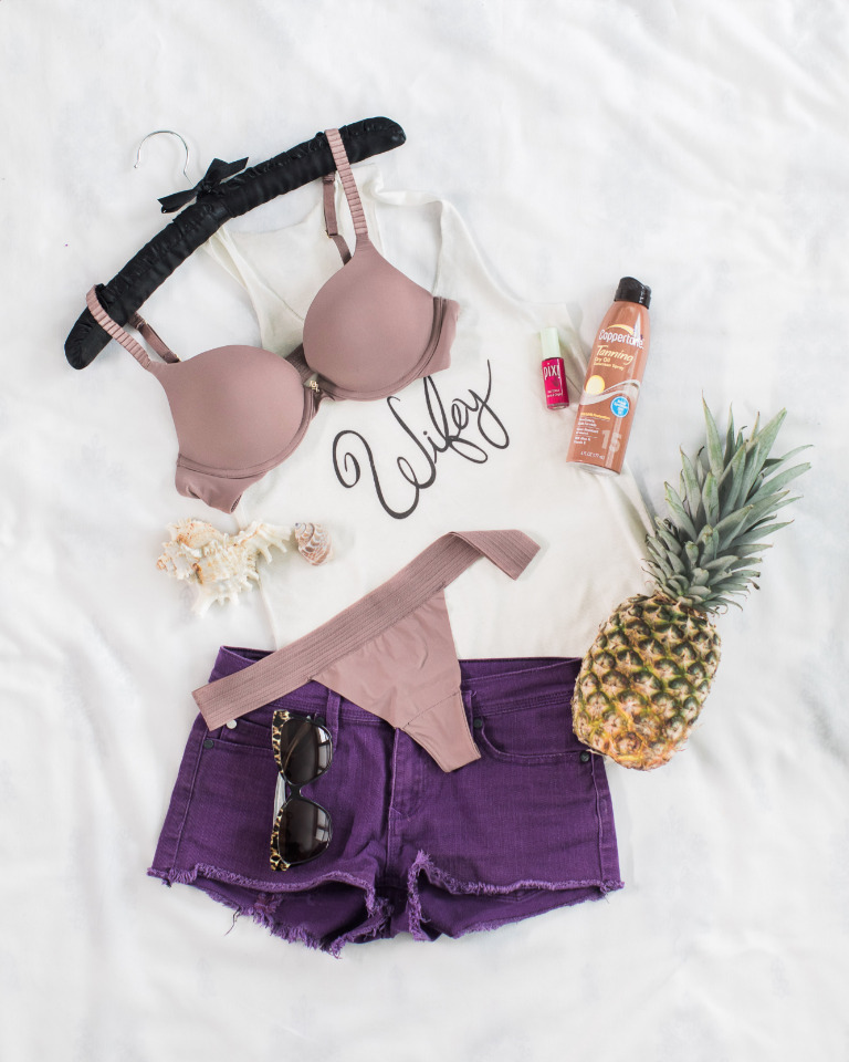 Beach essentials: bra, shorts, and pineapple for a sunny getaway