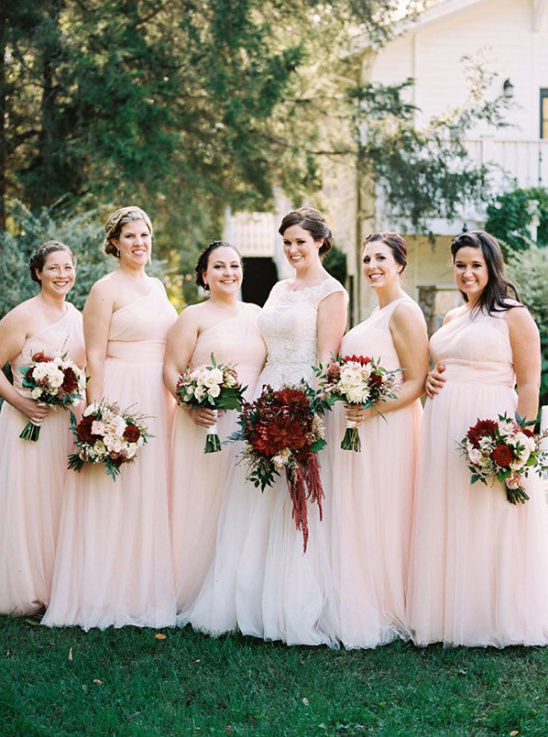 Bride with bridesmaids in pink dresses holding bouquets