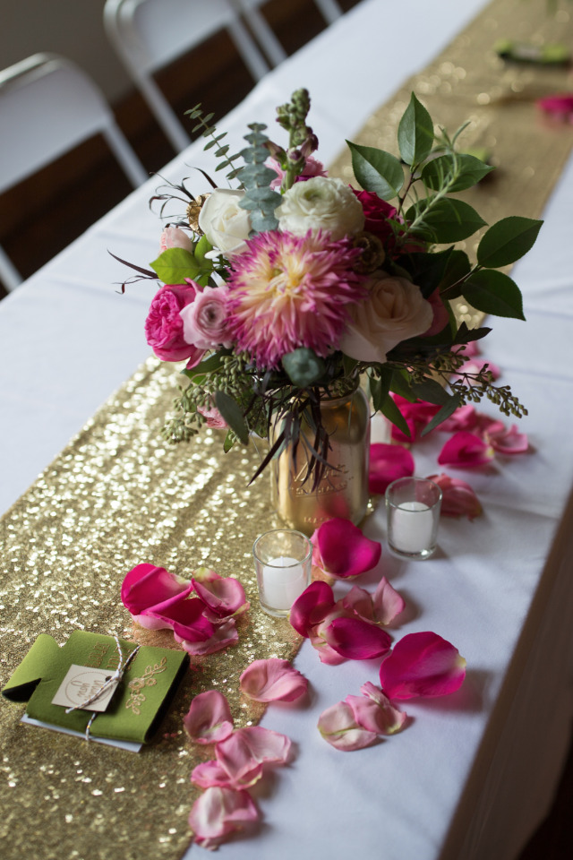 gold table runner and centerpiece with rose petal decor