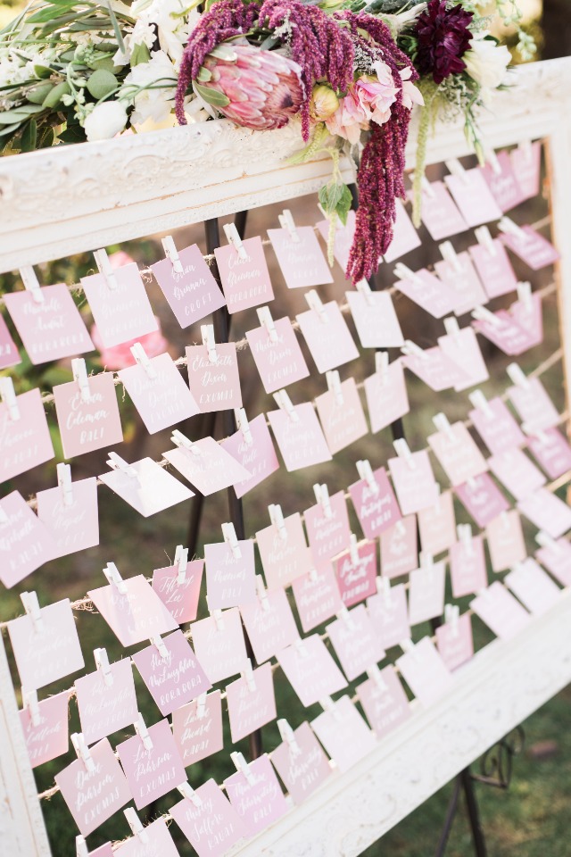 wedding escort cards in varying shades of pink
