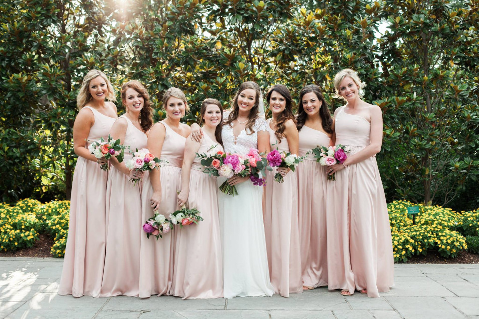 Bride and bridesmaids in blush pink gowns with bouquets