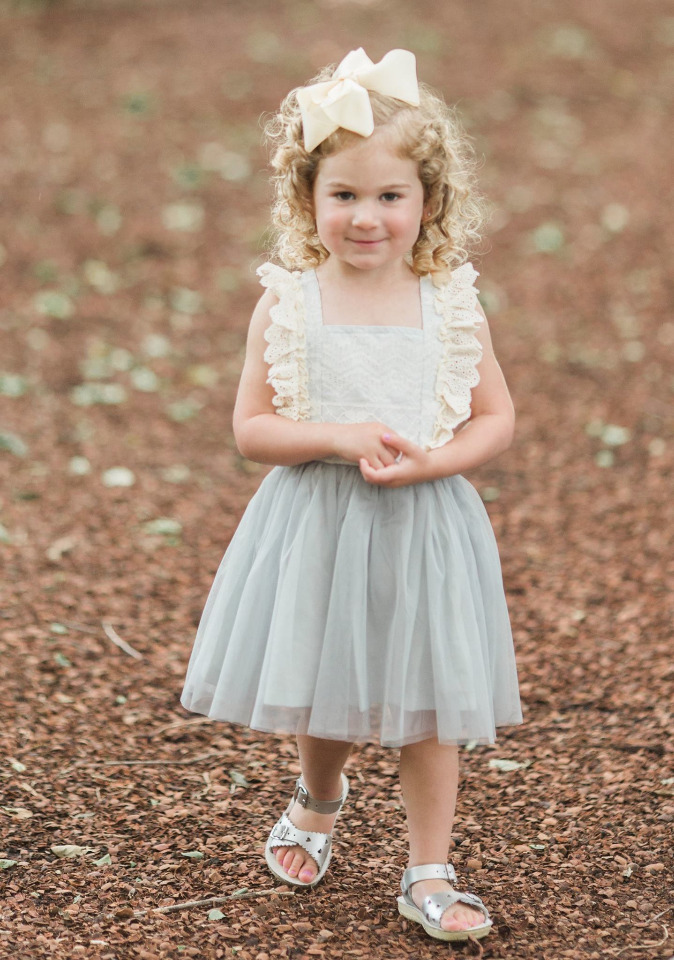 Adorable little girl in a tutu dress with a big hair bow
